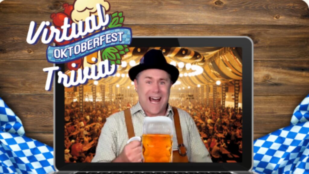 Event host on laptop in a beer house, holding a beer